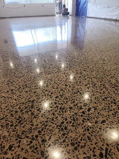Sealed concrete garage floor with exposed aggregate and a clear topcoat